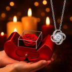 Romantic Christmas gift setup featuring a red heart rose box and silver love knot necklace on a cozy candle-lit table, symbolizing eternal love and perfect for holiday gifting.